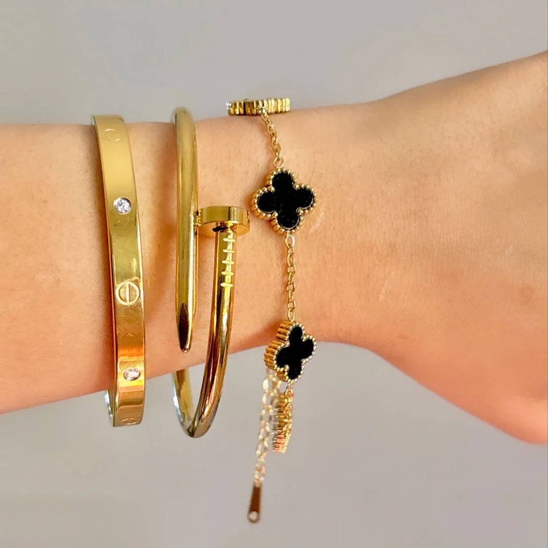 Cartier Nail, love bangle with black clover bracelet ‘Stack’ Zevare.pk